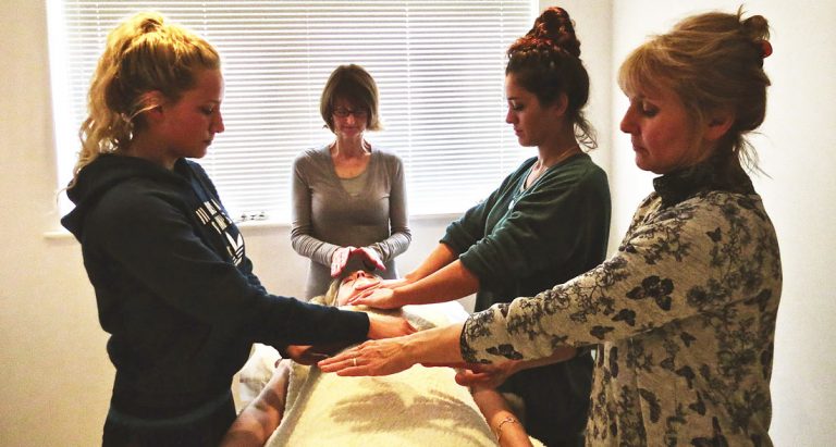 image of 4 ladies giving a reiki treatment